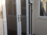 White aluminium French doors with side glass panel