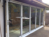 White flush aluminium bi-fold patio doors with 5 panels