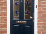 Coloured wood effect uPVC exterior door with diamond colour leaded glass style