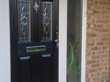 Coloured wood effect uPVC exterior door with ornate clear leaded glass style