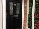 Coloured wood effect uPVC exterior door with diamond clear leaded glass style and matching top arch
