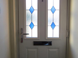 White wood effect uPVC interior door with diamond colour leaded glass style
