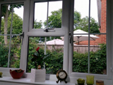 Interior view of triple pencil ogee profile uPVC double glazed window with classic hardware