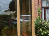 Exterior view of triple pencil ogee profile uPVC double glazed window in light oak