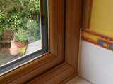 Interior view of double bullnose profile uPVC double glazed window in light oak